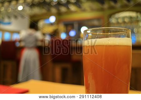 Glass Of German Wheat Beer On Table In Restaurant
