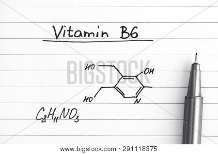 Chemical Formula Of Vitamin B6 With Pen. Close-up.