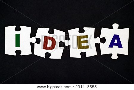 Four Pieces Of Puzzle With Letters Idea On Black Background