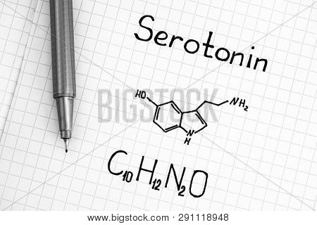 Chemical Formula Of Serotonin With Black Pen. Close-up.