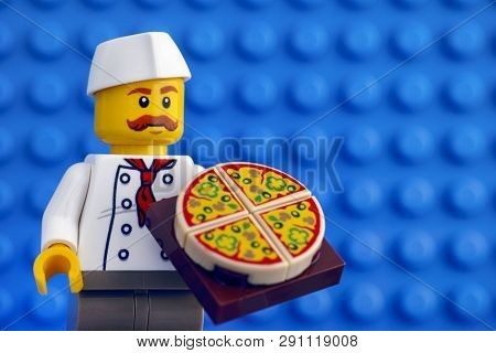 Tambov, Russian Federation - February 05, 2018 Lego Chef With Pizza Against Blue Baseplate Backgroun