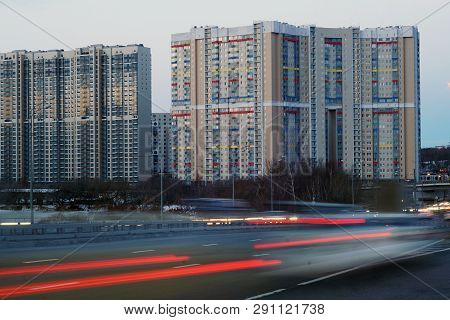 Modern Multi-storey Residential Building With A Colorful Design And Freeway In The Foreground. An Ex