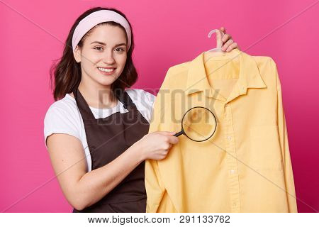 Studio Shot Of Pleasant Looking Housewife With Pleasent Look, Wears White Hair Band, Casual T Shirt,
