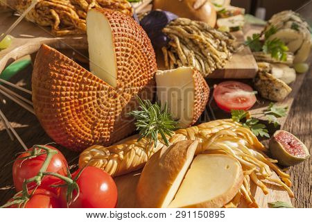 Smoked Cheese Pigtail, Traditional Polish Smoked Cheese, Chechil Cheese On The Wood Background. Smok