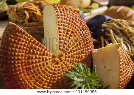 Smoked Cheese Pigtail, Traditional Polish Smoked Cheese, Chechil Cheese On The Wood Background. Smok