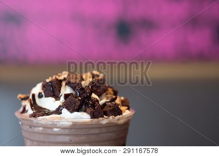 Whipping Cream With Chocolate And Brownies On Chocolate Frappe In Take Away Drink