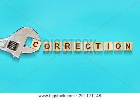 Correction, Word Written On Wooden Blocks, Adjustable Wrench On Blue Background.isolated. Error Corr