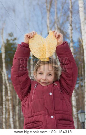 Girl With Pancake During Shrovetide. Spring Sunny Day