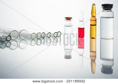Group Of Vials With Medication On Blue Methacrylate Table. Horizontal Composition.