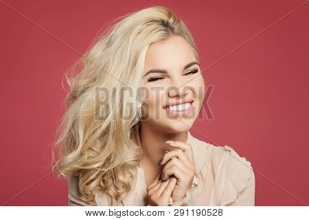 Young Happy Woman With Blonde Curly Bob Hairstyle Having Fun And Laughing Against Colorful Pink Wall