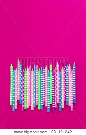 Bright Festive Candles In A Row On Trendy Fucsia Background In Flat Lay With Copy Space. Greeting Ha