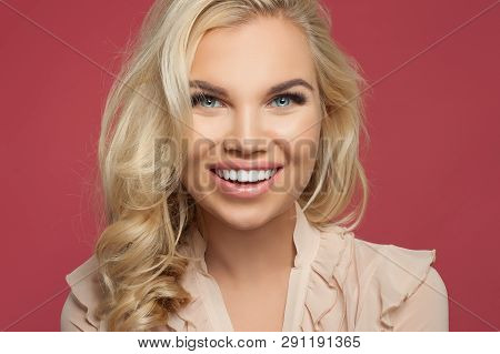 Happy Young Woman Face Closeup Portrait. Girl With Pretty Smile Over Pink
