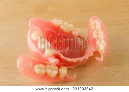 Large Image Of A Modern Denture On A Wooden Background