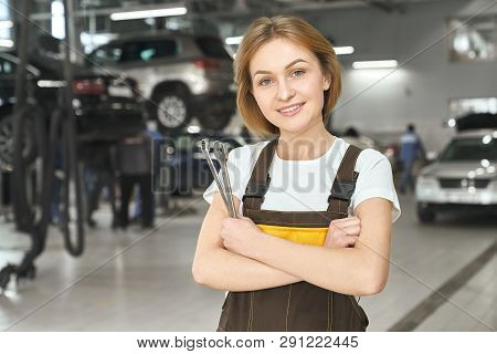 Charming Young Woman With Short Hair Wearing In White T Shirt, Brown Coveralls. Female Mechanic, Wor