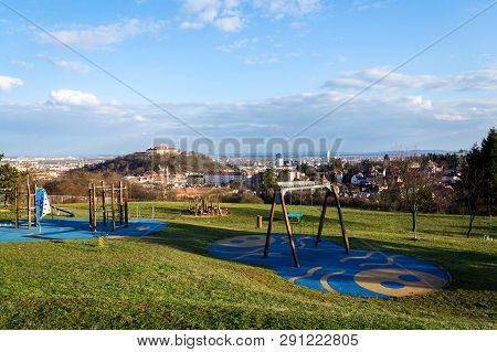 Beautiful Playground With Wooden Swing And Climbing Frames For Children With Spilberk Castle In Back