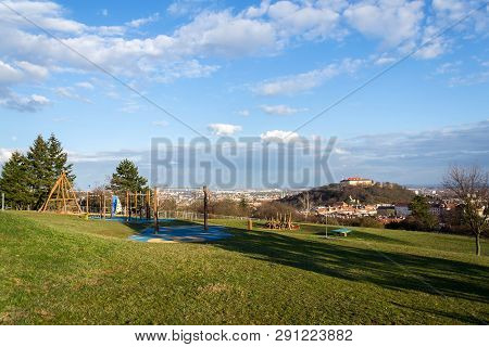 Beautiful Playground With Wooden Swing And Climbing Frames For Children With Spilberk Castle In Back