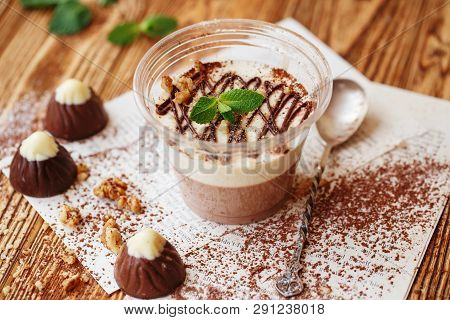 Italian Dessert Panakota With On A Wooden Background. Creamy Milk Tender Dessert In A Glass.