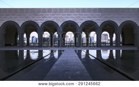 Looking Through The Arches Of The Museum Of Islamic Arts Across The Bay Towards The New City Skyline