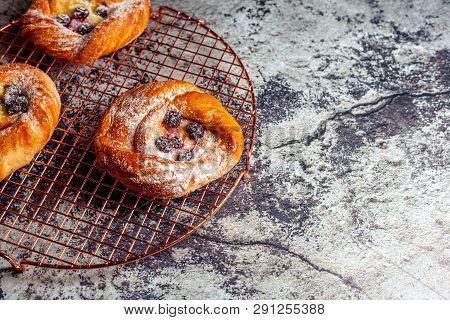 Top View Of Golden Chese Danish Pasties With Blackberries And Powder Sugar