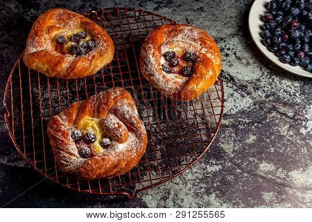Top View Of Golden Chese Danish Pasties With Blackberries And Powder Sugar