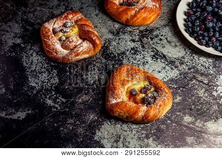 Top View Of Golden Chese Danish Pasties With Blackberries And Powder Sugar