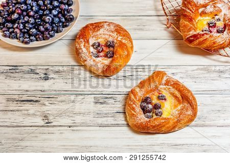 Top View Of Golden Chese Danish Pasties With Blackberries And Powder Sugar