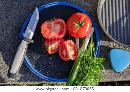 Tomato tomato sliced into slices. Cutting vegetables.