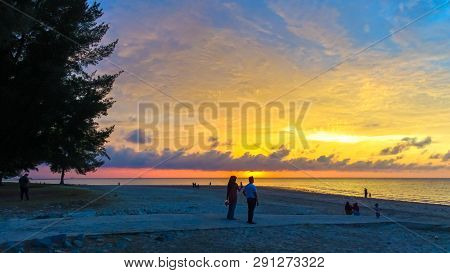 Labuan,malaysia-mac 9,2019:a Group Of People Gather To Watch The Sunset At Layang Layangan Beach In 