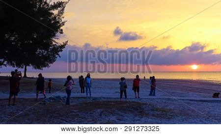 Labuan,malaysia-mac 9,2019:a Group Of People Gather To Watch The Sunset At Layang Layangan Beach In 