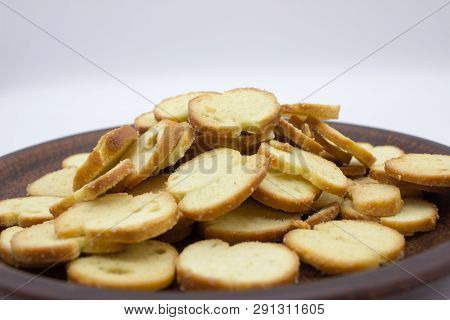 Bake Rolls. The Mini Bread Chips On The Brown Bowl. Isolated On White Background.
