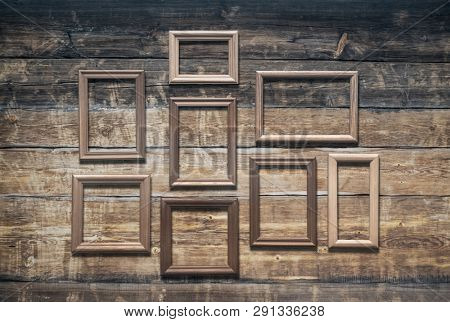 vintage poto frames on old wooden wall