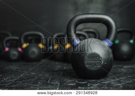 Kettlebell Equipment On Dark Backgroud At The Gym. Sport Concept. Copy Space
