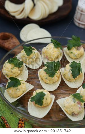 Appetizer On Chips With Salmon, Eggs And Cheese