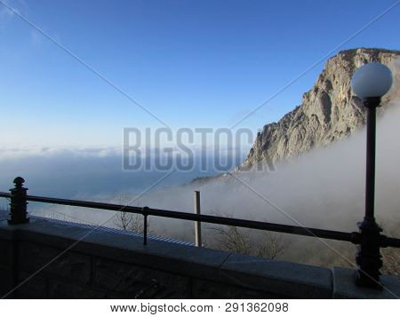 Clouds Descend To The Sea Through The Mountains.
