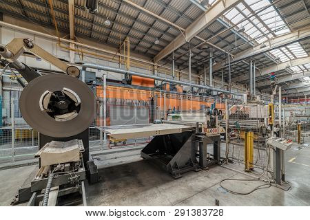 Cold Rolled Steel Coil On Decoiler Of Machine In Metalwork Manufacturing. Modern Equipment For Sheet