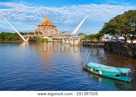 Kuching, Malaysia - March 11, 2019: Traditional Boat On Sarawak River, Scenic View Of State Legislat
