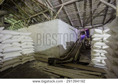 Theme Plant Storage Warehouse. A Lot Of White Fabric Bags With Loose Products Stacked In Piles Indoo