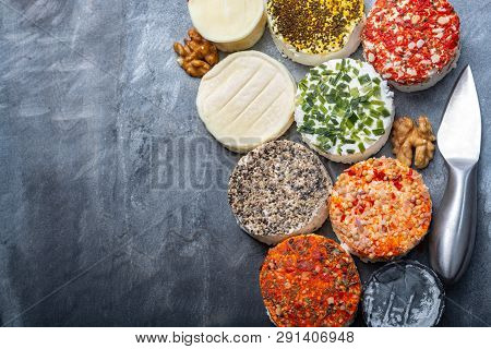 Assortment Of French Fresh White Soft Goat Cheeses With Different Tastes Topping Made With Herbs, Pa