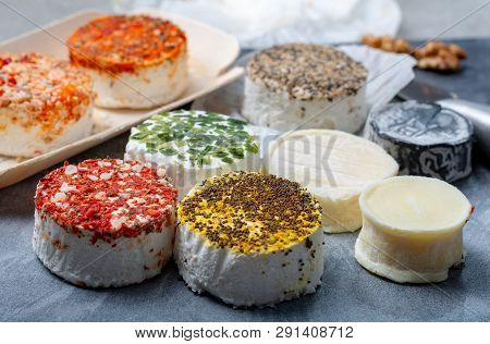 Assortment Of French Fresh White Soft Goat Cheeses With Different Tastes Topping Made With Herbs, Pa