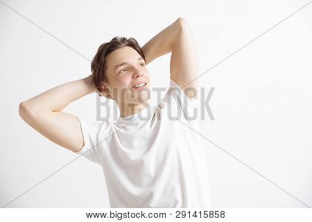 Looking For The Best Moment. Young Dreaming Smiling Teenager Waiting For Chanses Isolated On A Gray 