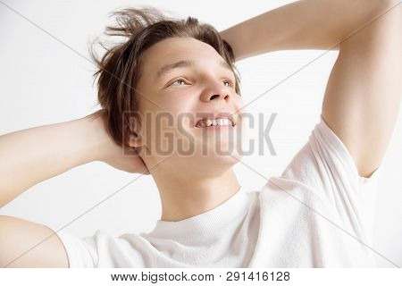 Looking For The Best Moment. Young Dreaming Smiling Teenager Waiting For Chanses Isolated On A Gray 