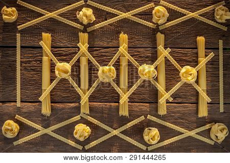 Pasta Placed With Geometric Signs On A Wooden Background