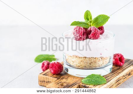 No Baked Cheesecake With Raspberry In Glass Jar. Healthy Dessert.