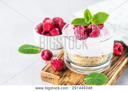 No Baked Cheesecake With Raspberry In Glass Jar. Healthy Dessert.