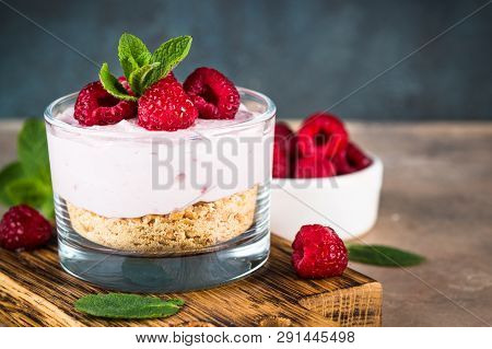 No Baked Cheesecake With Raspberry In Glass Jar. Healthy Dessert.