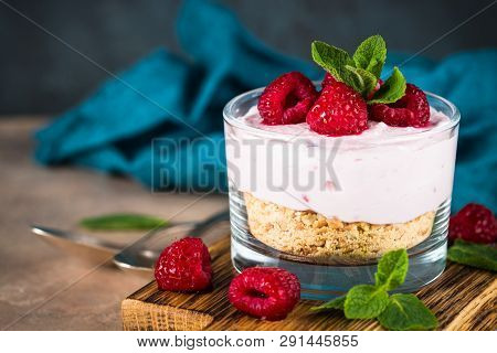 No Baked Cheesecake With Raspberry In Glass Jar. Healthy Dessert.