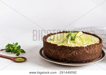 Delicious Homemade Cheesecake With Lime And Pepper Mint With Cup Of Coffee On White Table, Side View