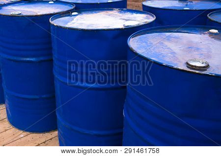 Colored Metal Barrels. Blue Oil Drums Containing Fuel For Transportation