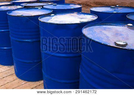 Colored Metal Barrels. Blue Oil Drums Containing Fuel For Transportation