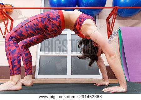 Young Sporty Woman Practicing Yoga, Doing Mahamudra Stretching Position In A Fitnes Club